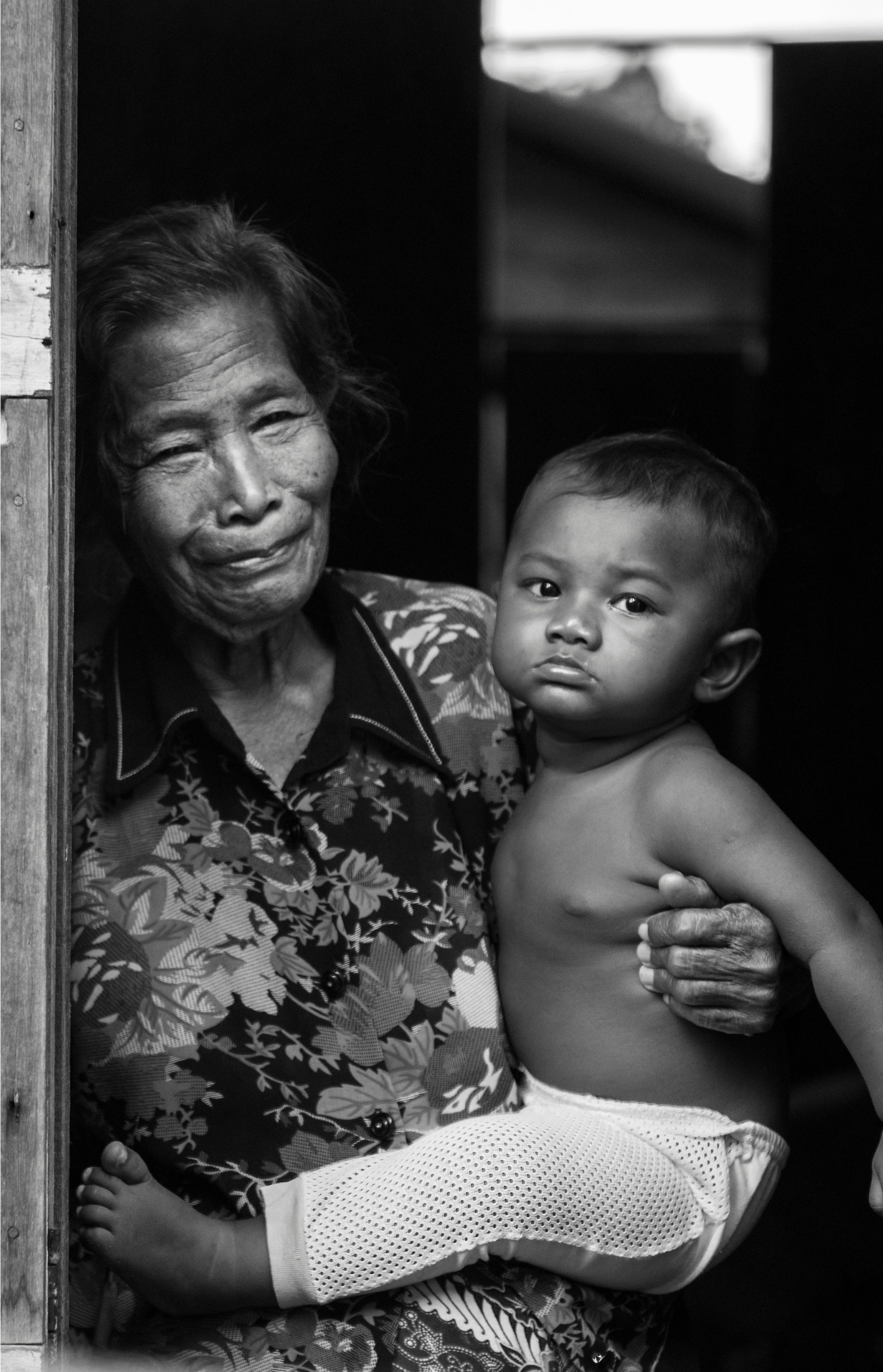 Picture of an old woman holding a baby.